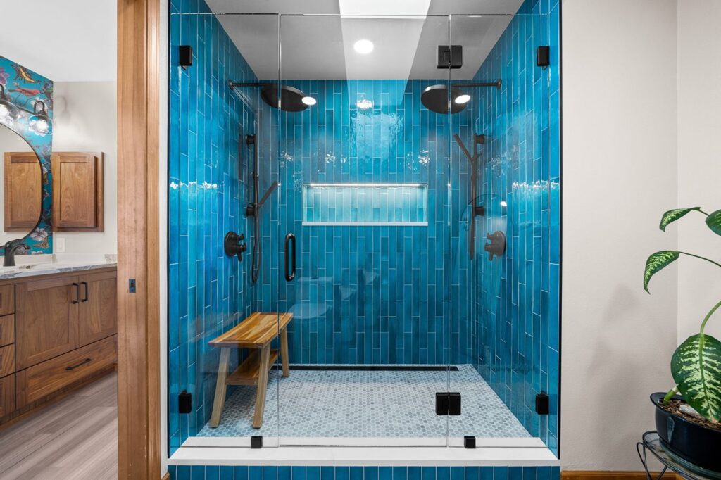 shower with bright blue tile and 2 shower heads